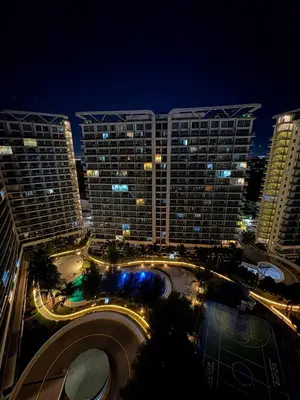 a view of a large building at night at Sunset and Breeze by Azure in Manila