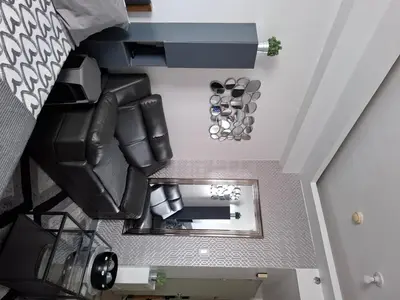 an overhead view of a room with a couch and a mirror at QUINS STAYCATION One Bedroom at SMDC South Residences in Manila