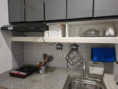 a kitchen with a sink and a counter top at QUINS STAYCATION One Bedroom at SMDC South Residences in Manila