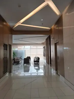 a lobby with chairs and tables in a building at QUINS STAYCATION One Bedroom at SMDC South Residences in Manila