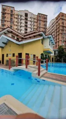 a large swimming pool in front of a building at Avida sm sucat condotel in Manila