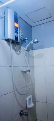 a shower with a hose in a bathroom with a toilet at Avida sm sucat condotel in Manila