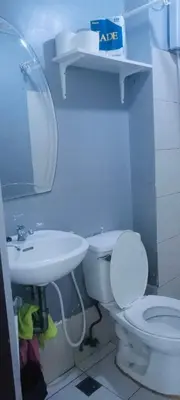 a bathroom with a white toilet and a sink at Avida sm sucat condotel in Manila