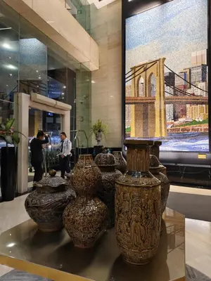 a group of vases sitting on a table in a store at Gramercy Residences Makati by Christine Suites PH with Balcony in Manila