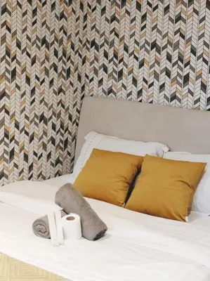 a bed with two pillows and two towels on it at Gramercy Residences Makati by Christine Suites PH with Balcony in Manila