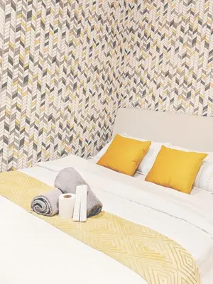 a bed with two pillows and towels on it at Gramercy Residences Makati by Christine Suites PH with Balcony in Manila