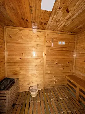 an inside of a wooden sauna with a bucket at BGC condo for rent in taguig in Manila