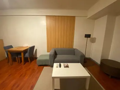 a living room with a couch and a table at BGC condo for rent in taguig in Manila