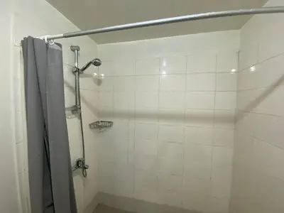a bathroom with a shower with a shower curtain at BGC condo for rent in taguig in Manila