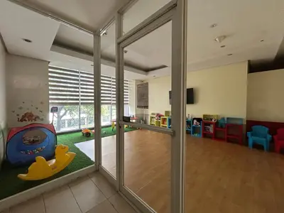 a room with a playroom with a sliding glass door at BGC condo for rent in taguig in Manila