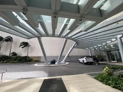 a building with a car parked in a parking lot at BGC condo for rent in taguig in Manila