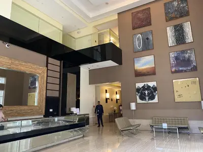 a man standing in the lobby of a building at BGC condo for rent in taguig in Manila