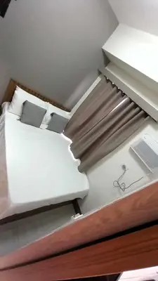 a room with a bed with a desk and a laptop at Cozy and Luxurious Condominium in Manila