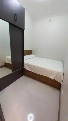 a small bedroom with two beds in a room at Cozy and Luxurious Condominium in Manila