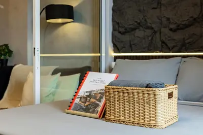 a table with a basket and a book on it at Casa Attila - Azure Urban Resort Residences in Manila