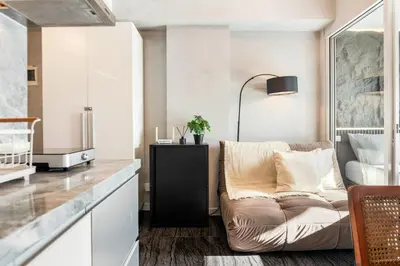 a living room with a couch and a table at Casa Attila - Azure Urban Resort Residences in Manila