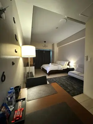 a hotel room with a bed and a couch at 81 Newport Blvd Cluster 5 unit 5K by Rechelle Nunag in Manila