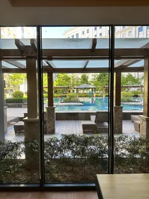 a view of a pool from inside a building at 81 Newport Blvd Cluster 5 unit 5K by Rechelle Nunag in Manila