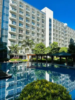 a large building with a pool in front of it at 81 Newport Blvd Cluster 5 unit 5K by Rechelle Nunag in Manila