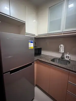 a kitchen with a stainless steel refrigerator and a sink at 81 Newport Blvd Cluster 5 unit 5K by Rechelle Nunag in Manila