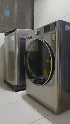 a washing machine sitting on the floor in a kitchen at 1 Master BR with full bathroom and JET TUB plus 2nd BR with full bathroom Elegant fully furnished with hotel feels in Manila