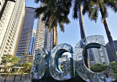a large metal sign that says ego in a city at Plant Box Apartment in Manila