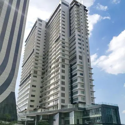 a tall white building with a sky at Plant Box Apartment in Manila