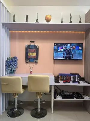 a office with a desk with two chairs and a tv at Smdc shore 2 tower 2 in Manila