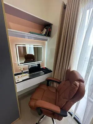 a room with a chair and a desk with a computer at Smdc shore 2 tower 2 in Manila