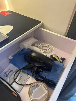 a box with a corded phone and a charger at Smdc shore 2 tower 2 in Manila