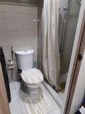 a bathroom with a toilet and a shower at Smdc shore 2 tower 2 in Manila