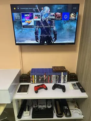 a shelf with video games and a tv on a wall at Smdc shore 2 tower 2 in Manila
