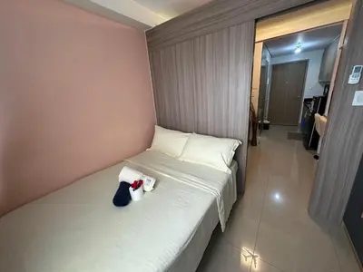 a bedroom with a bed with stuffed animals on it at Smdc shore 2 tower 2 in Manila