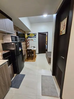 a kitchen with a refrigerator and a dining room at Condo Suite 1 Bedroom McKinley West Taguig City in Manila