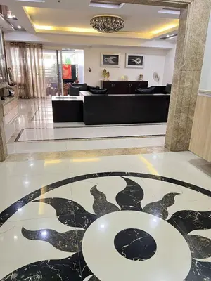 a lobby with a table in the middle of a room at R&R Entire Rental Unit in Manila