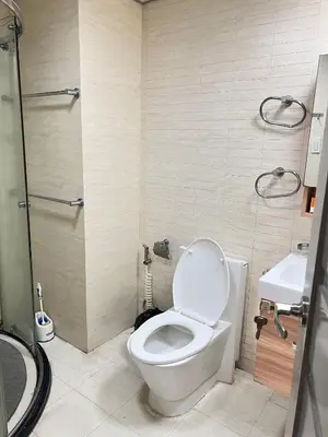 a bathroom with a toilet and a sink at R&R Entire Rental Unit in Manila
