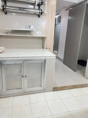 a kitchen with a white counter top and a room at R&R Entire Rental Unit in Manila