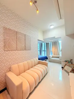 a living room with a couch in a room at Relaxing and Comfy in Manila