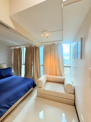 a bedroom with a bed and a window at Relaxing and Comfy in Manila