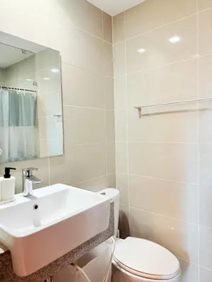 a white bathroom with a sink and a toilet at Relaxing and Comfy in Manila