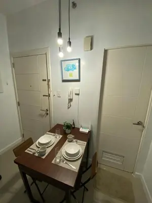 a room with a table with plates on it at Prime Location and Affordable Studio Condo in Legaspi Village, Makati with City view in Manila