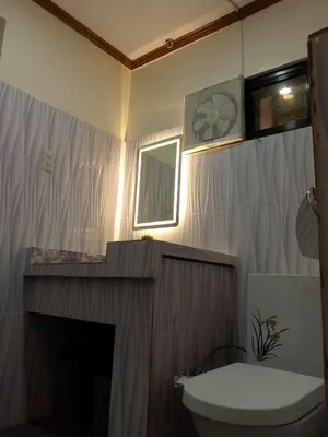 a bathroom with a fireplace and a toilet in it at CasaCavite - Your Chill Hideaway and Mini-Resort Just Minutes from all the Tagaytay-Silang-Nuvali Action! in Silang
