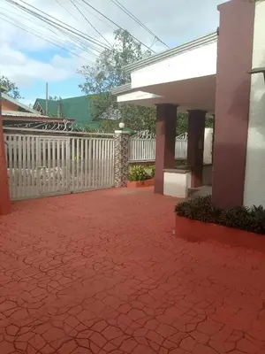 a patio with a white fence and a red brick sidewalk at CasaCavite - Your Chill Hideaway and Mini-Resort Just Minutes from all the Tagaytay-Silang-Nuvali Action! in Silang