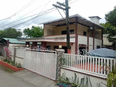 a house with a white fence in front of it at CasaCavite - Your Chill Hideaway and Mini-Resort Just Minutes from all the Tagaytay-Silang-Nuvali Action! in Silang