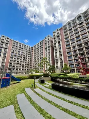 a large apartment building with a park in front of it at Monarch Park-suites Condominium in Manila