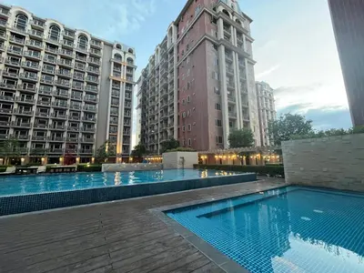 a swimming pool in the middle of two buildings at Monarch Park-suites Condominium in Manila
