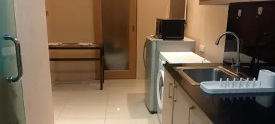 a small kitchen with a sink and a refrigerator at Shell Residence in Manila