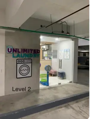 a building with a sign that reads unlimited laundry at Fame Tower1 2-Bedrooms All Rms w Aircon Washer Balcony in Manila