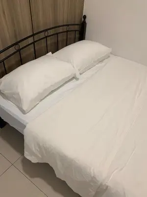 a large white bed with white sheets and pillows at Fame Tower1 2-Bedrooms All Rms w Aircon Washer Balcony in Manila