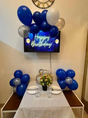 a table with a bunch of blue and white balloons at la Chicka - 295 T3 in Manila